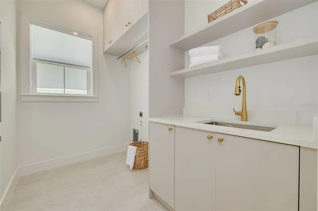 a kitchen with a refrigerator and white cabinets