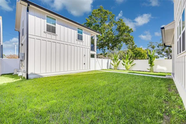 a view of a room with wooden floor and windows
