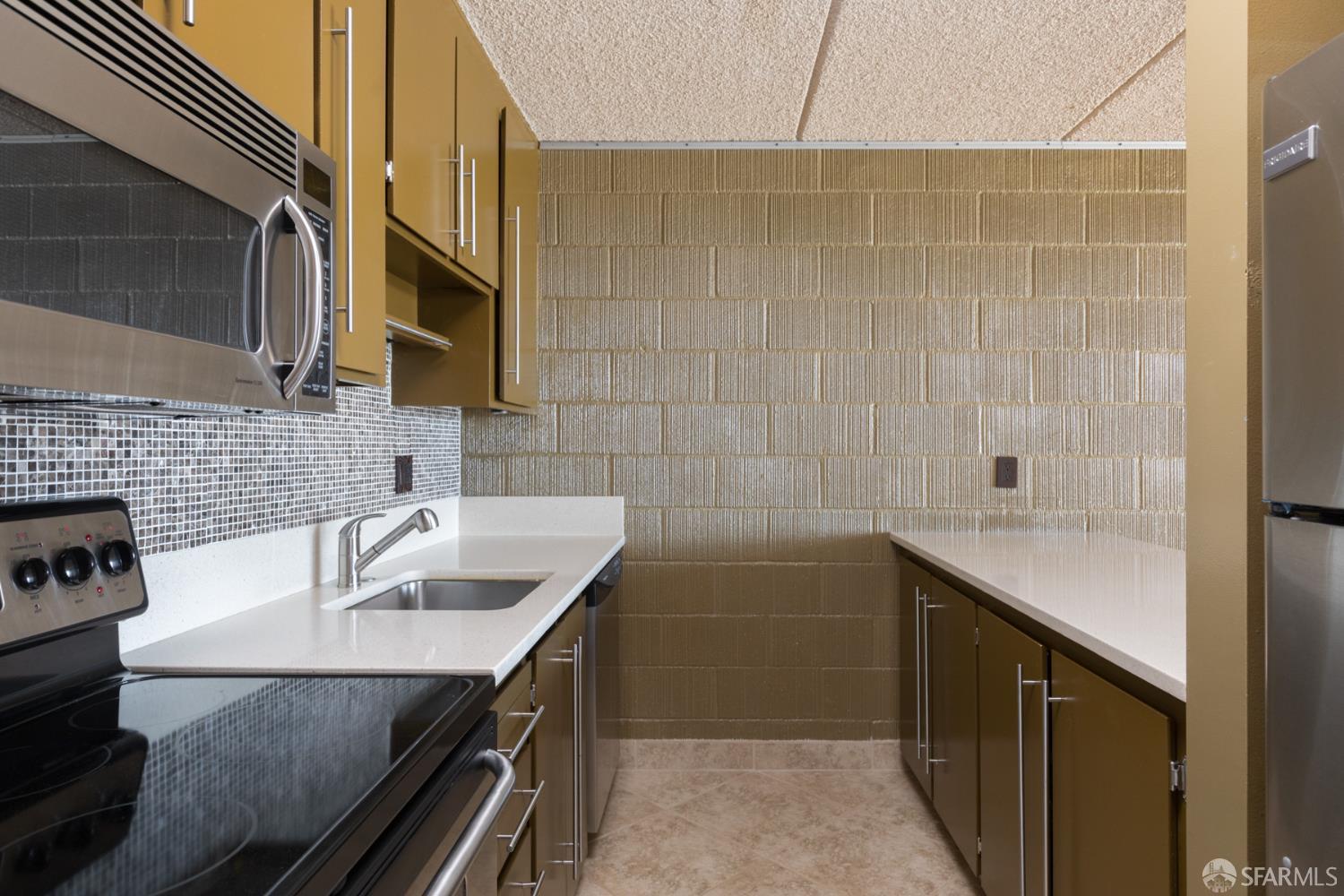 1 Kelton Court, Unit 1E Oakland, CA 94611 - Photo 4 of 23 a kitchen with a sink and cabinets