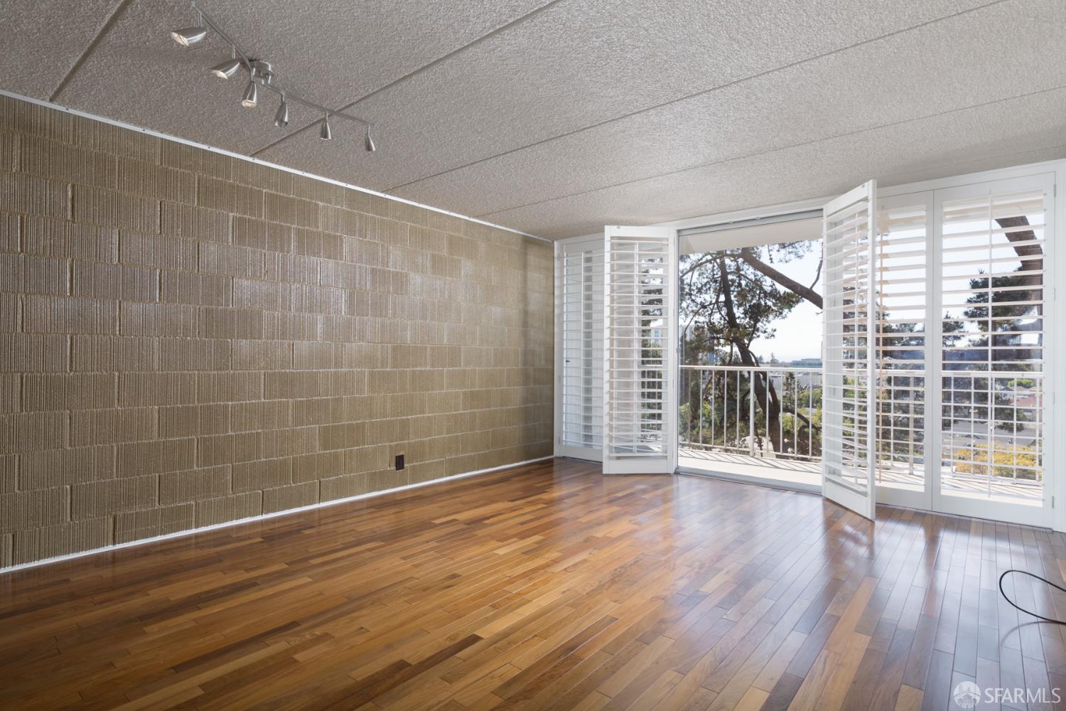 1 Kelton Court, Unit 1E Oakland, CA 94611 - Photo 7 of 23 a view of a room with wooden floor and window