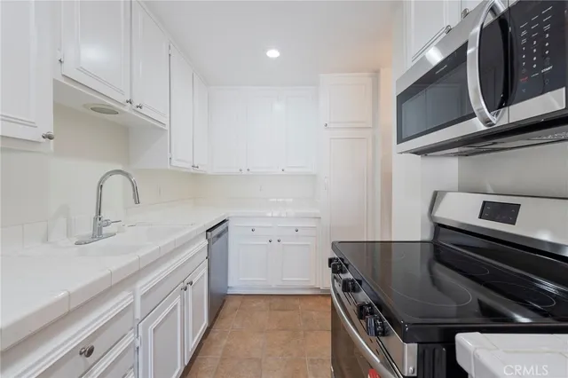 a kitchen with a sink appliances and cabinets