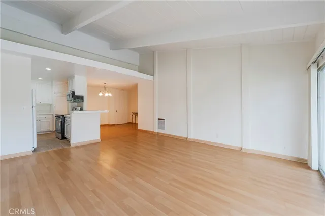 a view of a kitchen with wooden floor and a kitchen