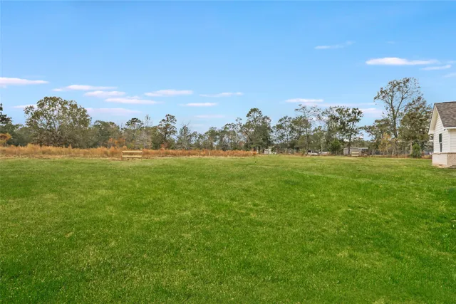 a view of a house with a yard and potted plants