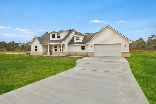 a view of a big house with a swimming pool and lawn chairs