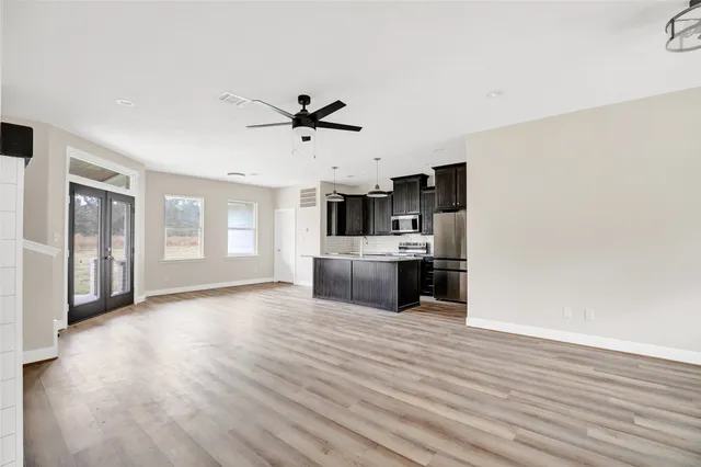 a large white kitchen with a cabinetry and kitchen view