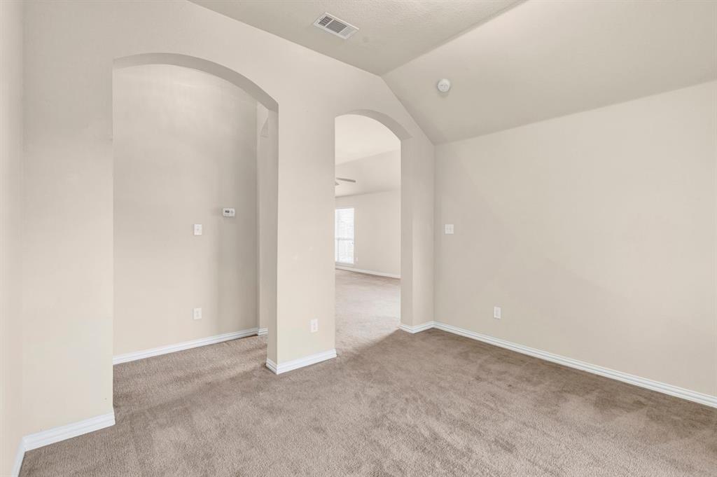 5316 Ridgeson Drive McKinney, TX 75071 - Photo 18 of 33 Archways define separate areas within an open layout, featuring vaulted ceilings and neutral wall tones