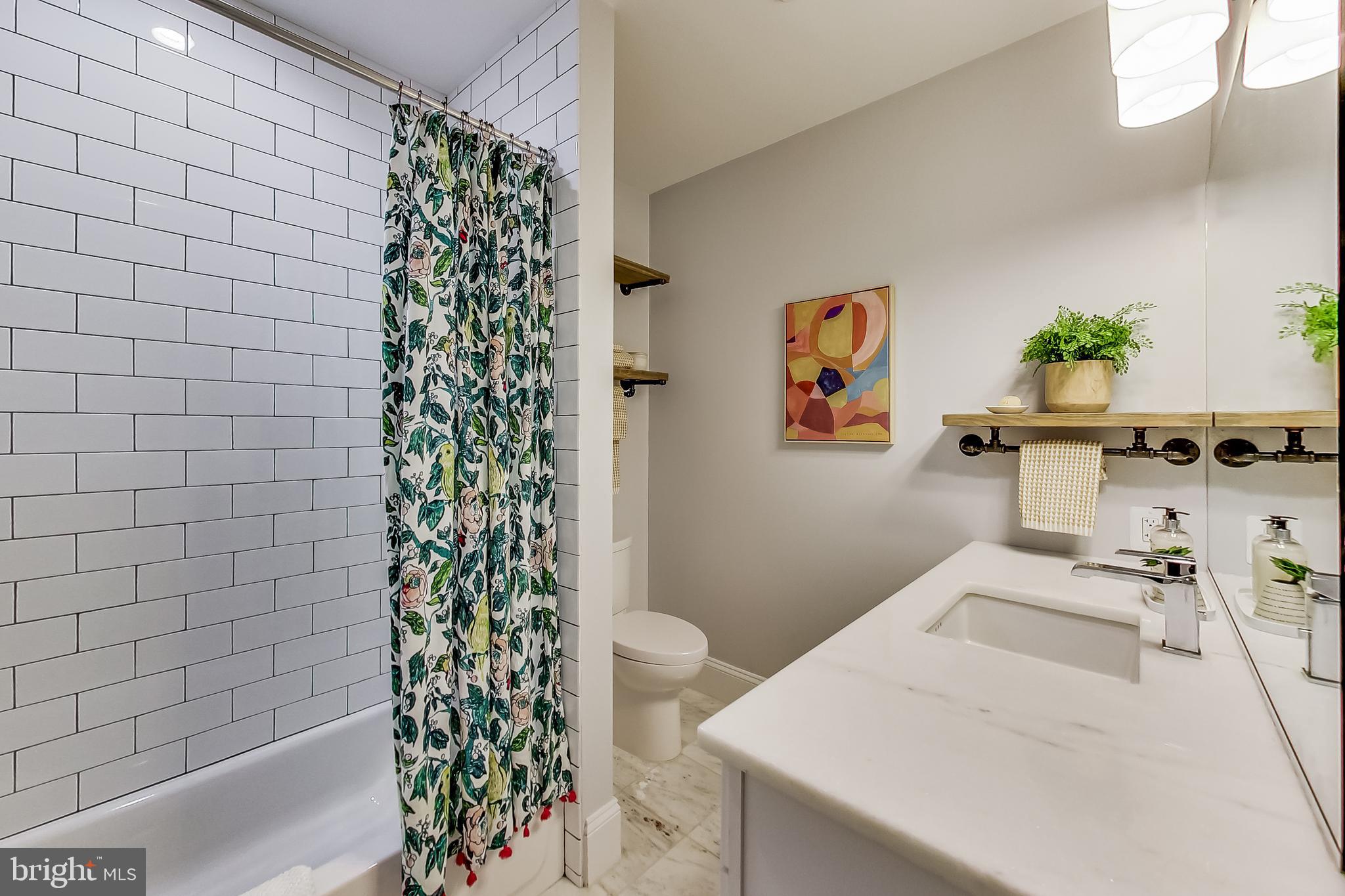 819 D Street Northeast, Unit 7 Washington, DC 20002 - Photo 11 of 20 a bathroom with a sink a toilet and shower