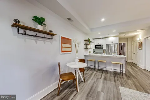 a view of a dining room with furniture and wooden floor