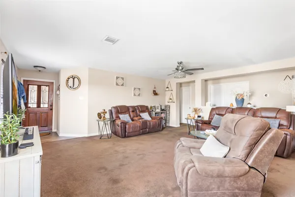 a living room with furniture and a chandelier