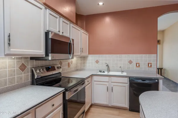 a kitchen with window and cabinets