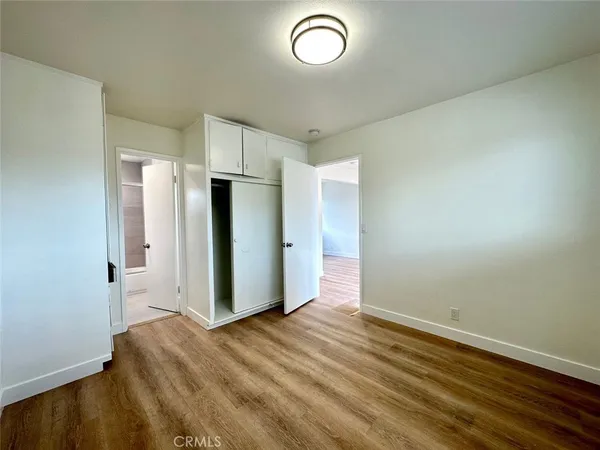 a view of room with window and wooden floor