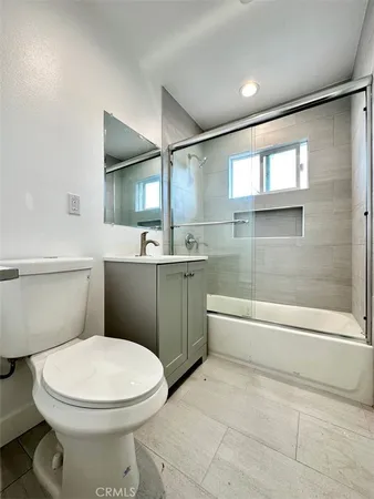 a bathroom with a sink a toilet and bathtub