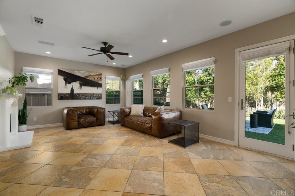 832 Genoa Way San Marcos, CA 92078 - Photo 13 of 42 a living room with furniture a flat screen tv and a fireplace