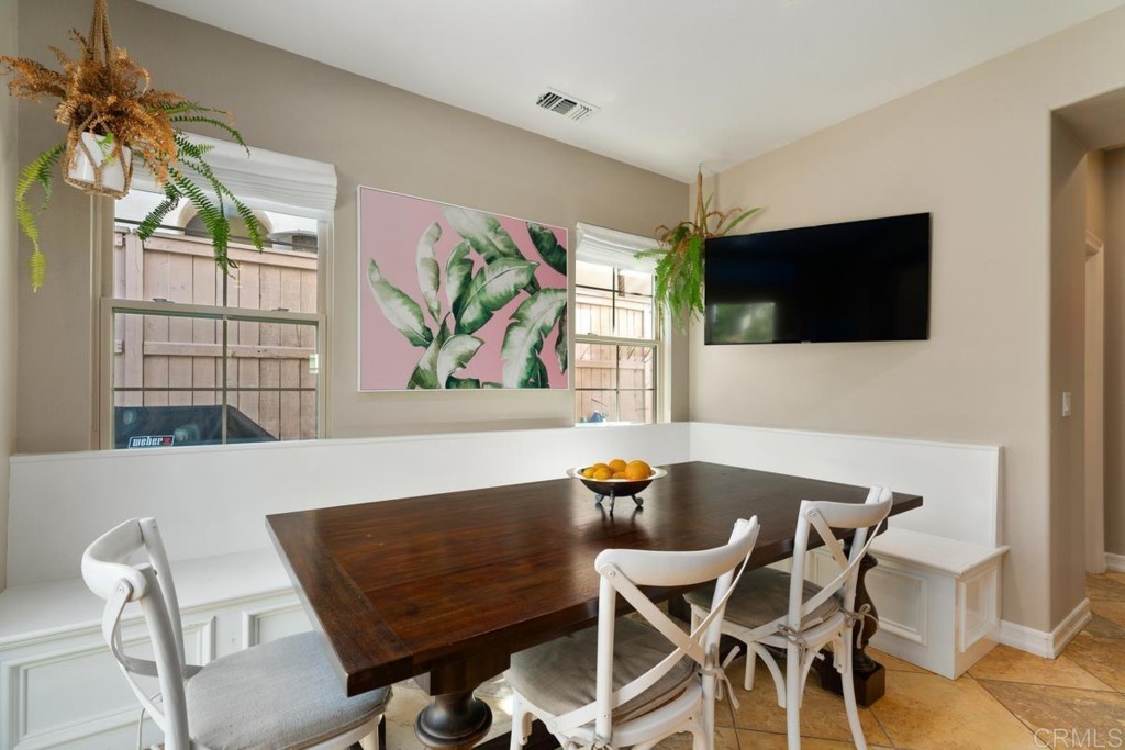 832 Genoa Way San Marcos, CA 92078 - Photo 24 of 42 a view of a dining room with furniture and a flat screen tv