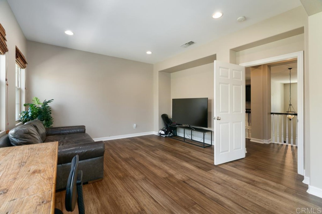 832 Genoa Way San Marcos, CA 92078 - Photo 32 of 42 a living room with furniture and a flat screen tv