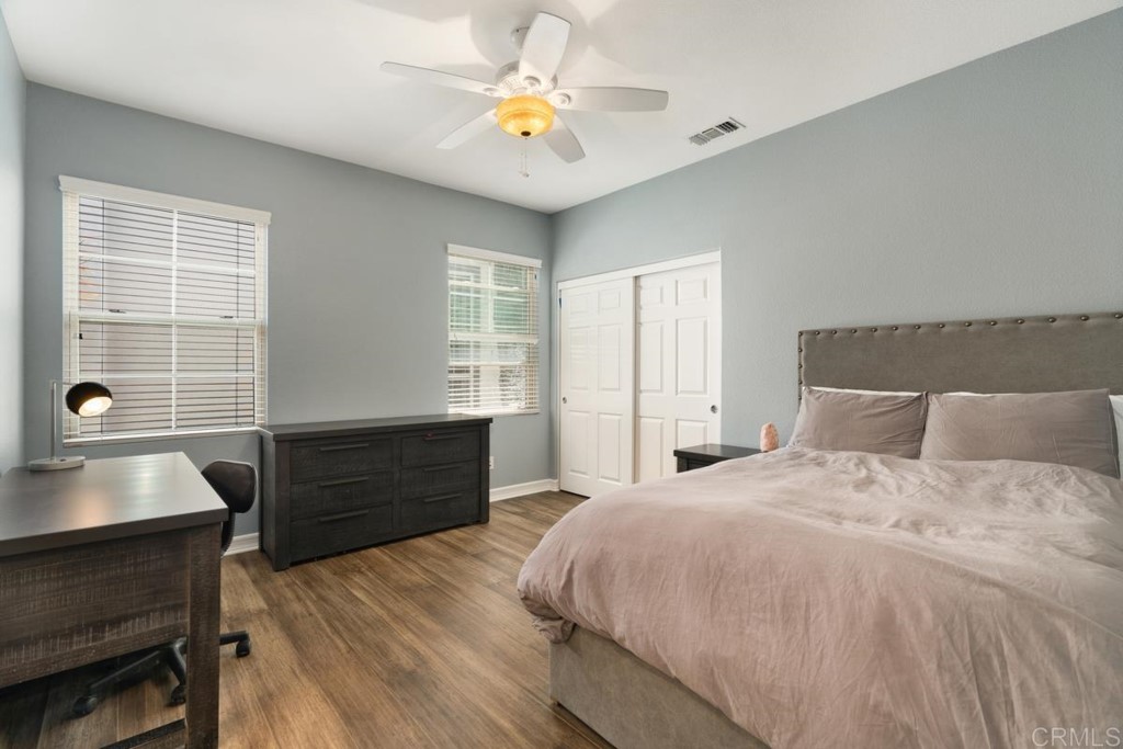 832 Genoa Way San Marcos, CA 92078 - Photo 37 of 42 a bedroom with a bed and a desk with stool
