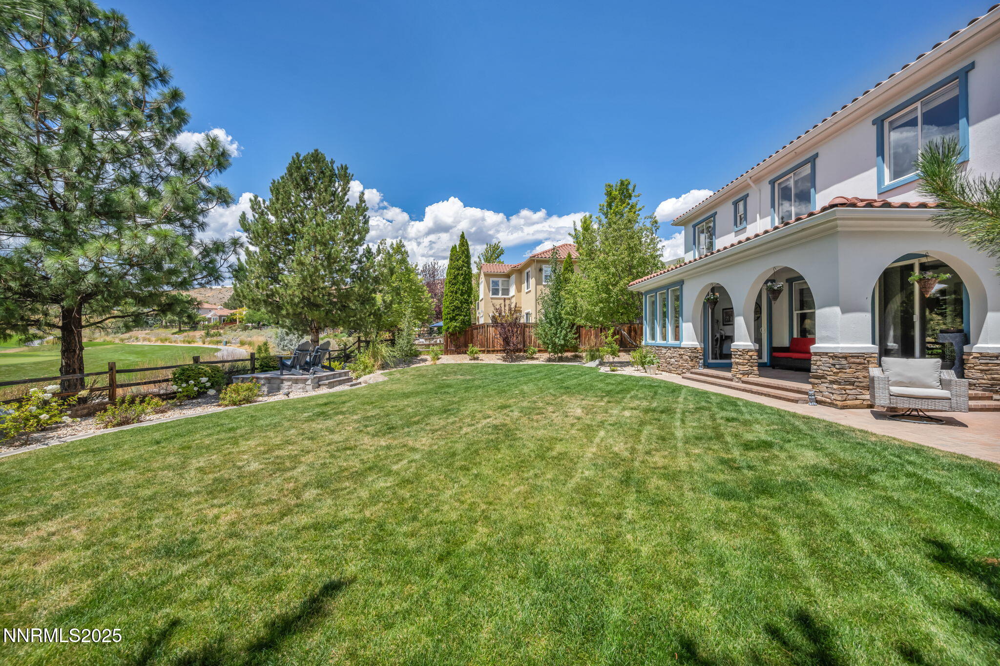 8200 Antler Pointe Court Reno, NV 89523 - Photo 4 of 36 a view of a white house with a big yard and large tree