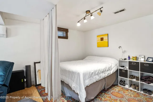 a bedroom with a bed and a desk