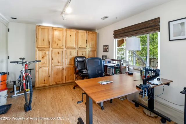 a room with furniture pool table and windows