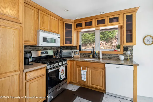 a kitchen with stainless steel appliances granite countertop a stove and a sink