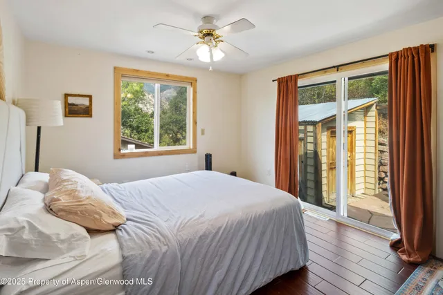 a bedroom with a large bed and a window
