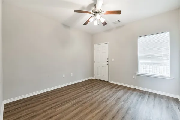 wooden floor in an empty room with a window