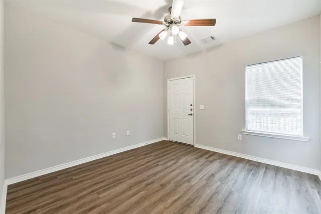 wooden floor in an empty room with a window