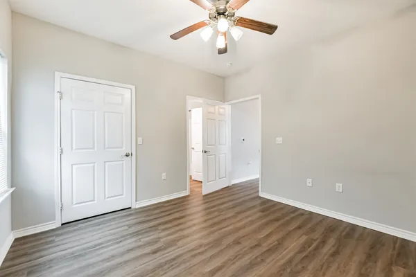 a view of an empty room and wooden floor