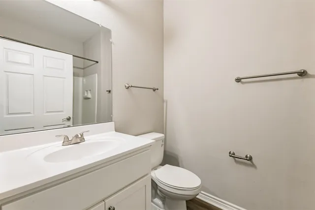 a bathroom with a sink toilet and a mirror