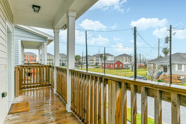 a view of balcony with wooden floor