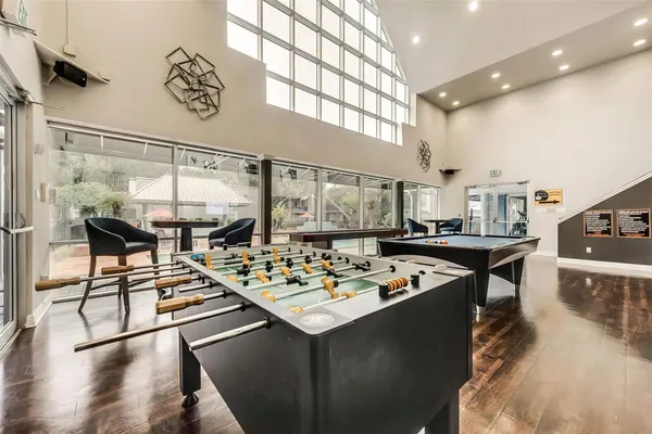 a living room with furniture a table and kitchen view