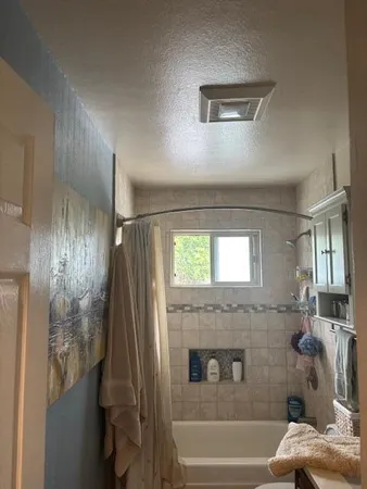 a bathroom with a tub and shower