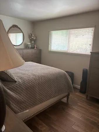 a bedroom with a bed and window