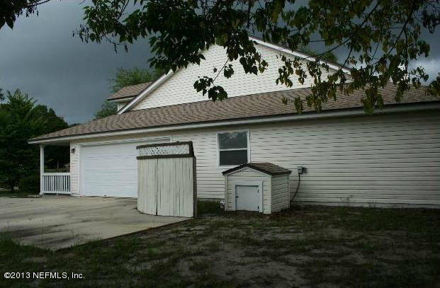 97089 Castle Ridge Drive Yulee, FL 32097 - Photo 5 of 9 a view of a back yard of the house