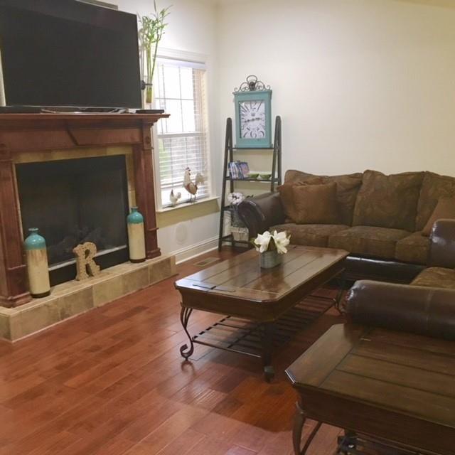 88 Lower Simmons Road Macon, GA 31220 - Photo 28 of 43 a living room with furniture a table and a fireplace