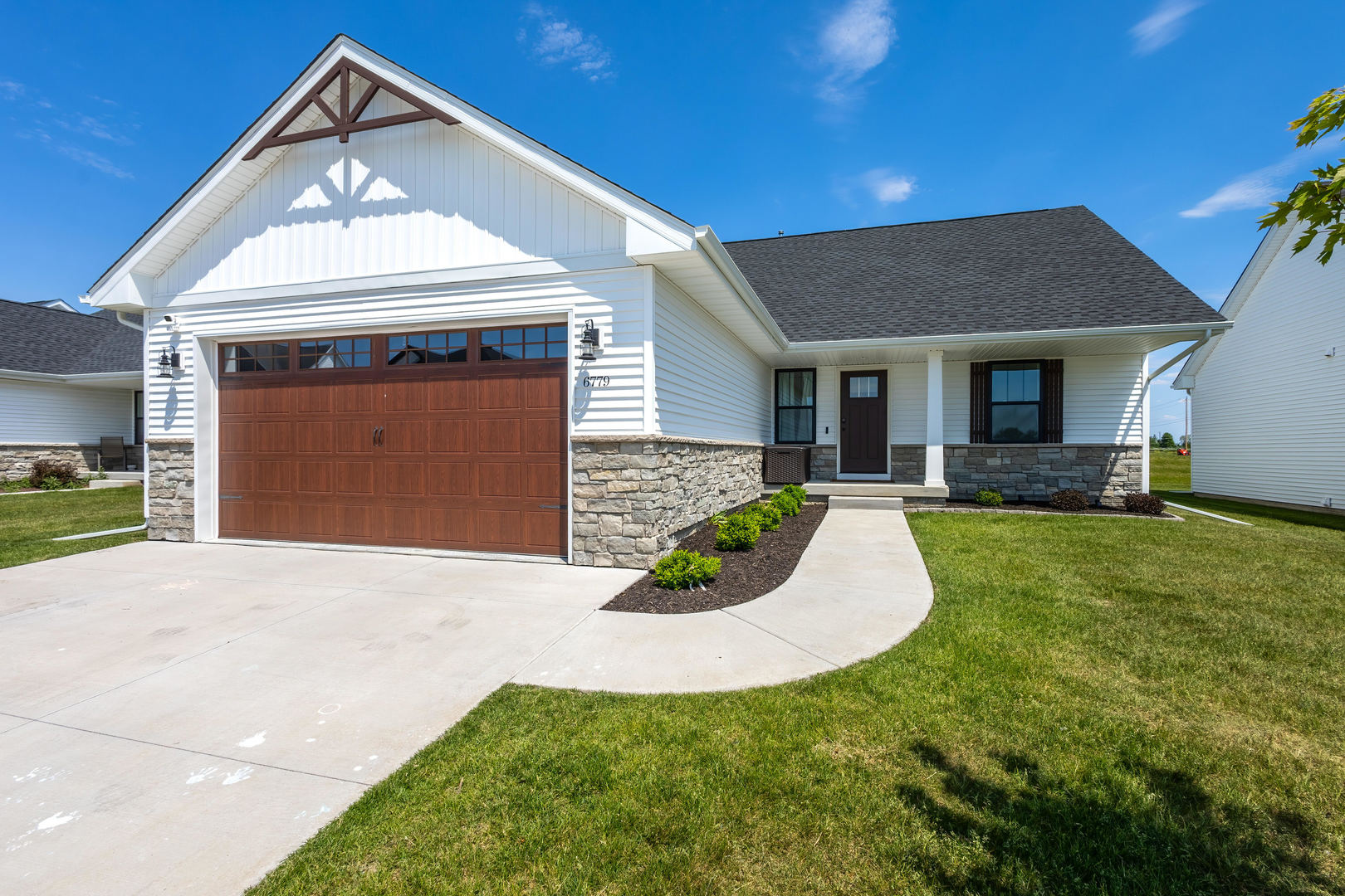 6779 Genesis Way Bettendorf, IA 52722 - Photo 1 of 36 a view of a house with a yard and garage