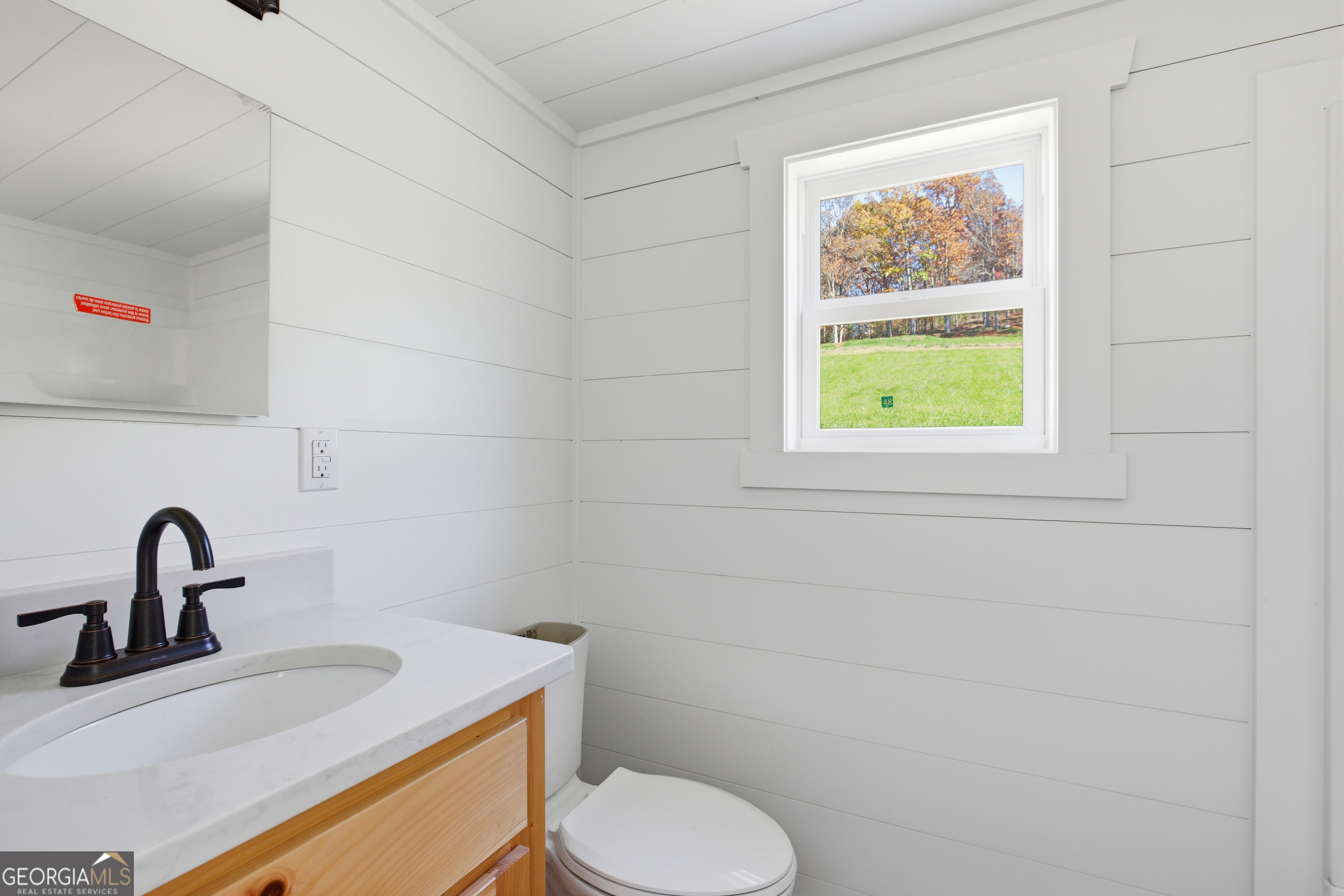 527 Saunders Road Franklin, NC 28734 - Photo 14 of 22 a bathroom with a toilet sink and mirror
