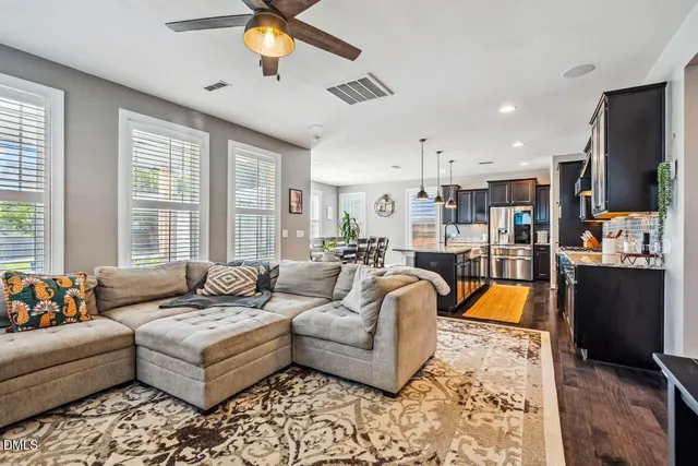 a kitchen with appliances cabinets and a wooden floor