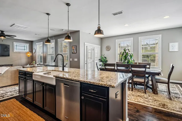 a bedroom with a bed a dresser and chair