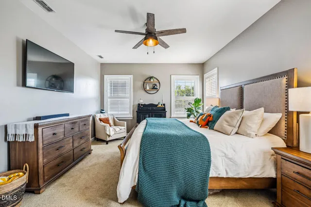 a view of a backyard with plants and tree