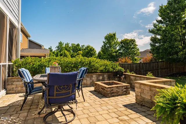 a front view of a house with a garden and trees