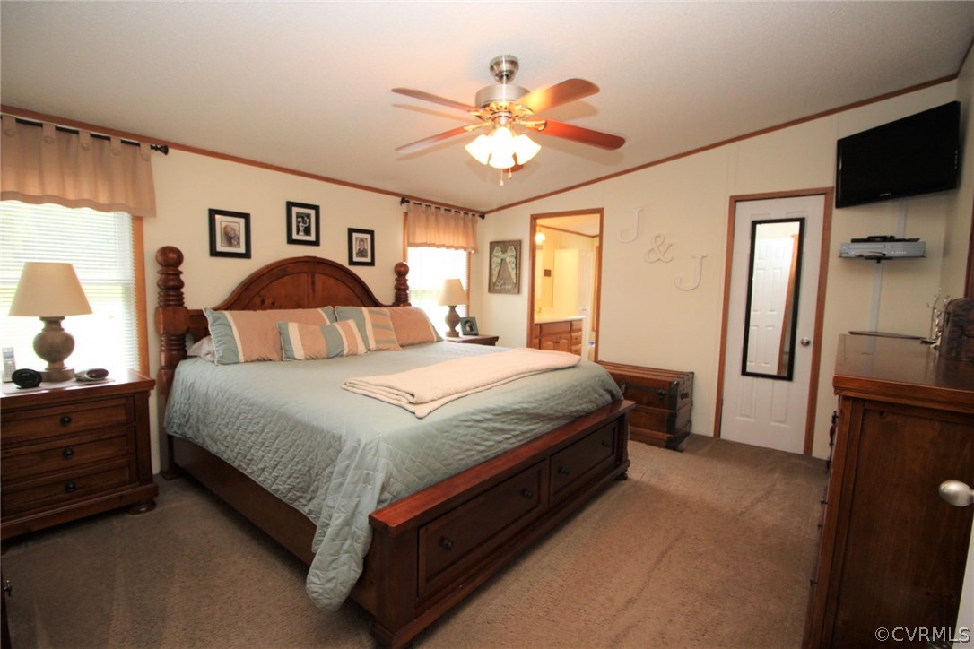 4278 Dorrell Road Aylett, VA 23009 - Photo 12 of 34 a spacious bedroom with a bed and a chandelier