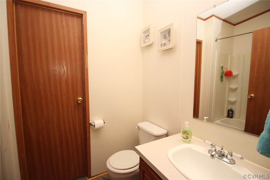 4278 Dorrell Road Aylett, VA 23009 - Photo 18 of 34 a bathroom with a sink a toilet and shower curtain