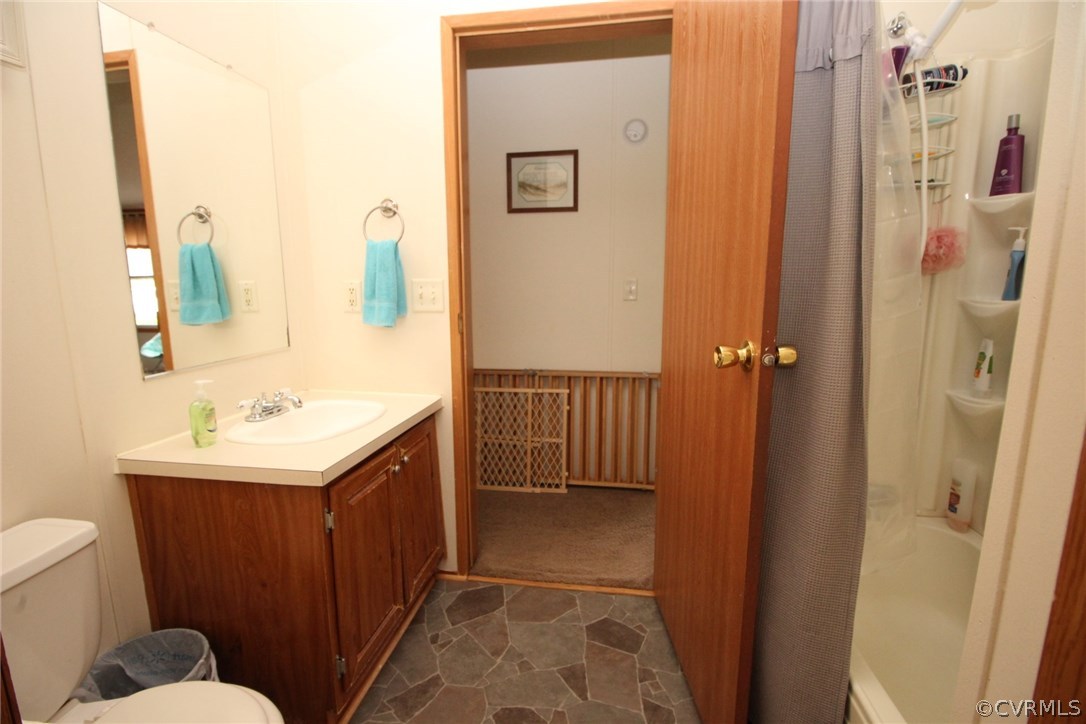 4278 Dorrell Road Aylett, VA 23009 - Photo 19 of 34 a bathroom with a sink a toilet a mirror and shower