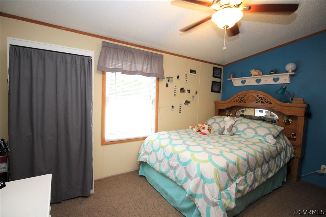 4278 Dorrell Road Aylett, VA 23009 - Photo 20 of 34 a bedroom with a bed and a chandelier