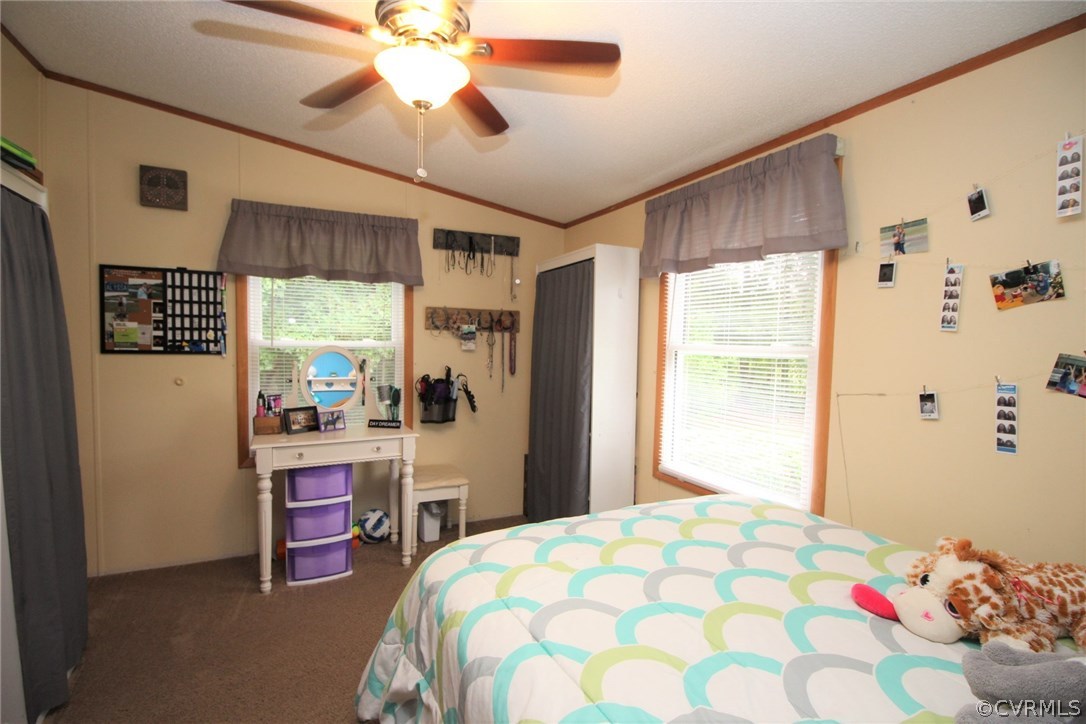 4278 Dorrell Road Aylett, VA 23009 - Photo 21 of 34 a bedroom with a bed and a chandelier