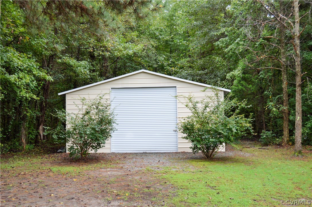 4278 Dorrell Road Aylett, VA 23009 - Photo 23 of 34 a front view of a house with a yard and garage