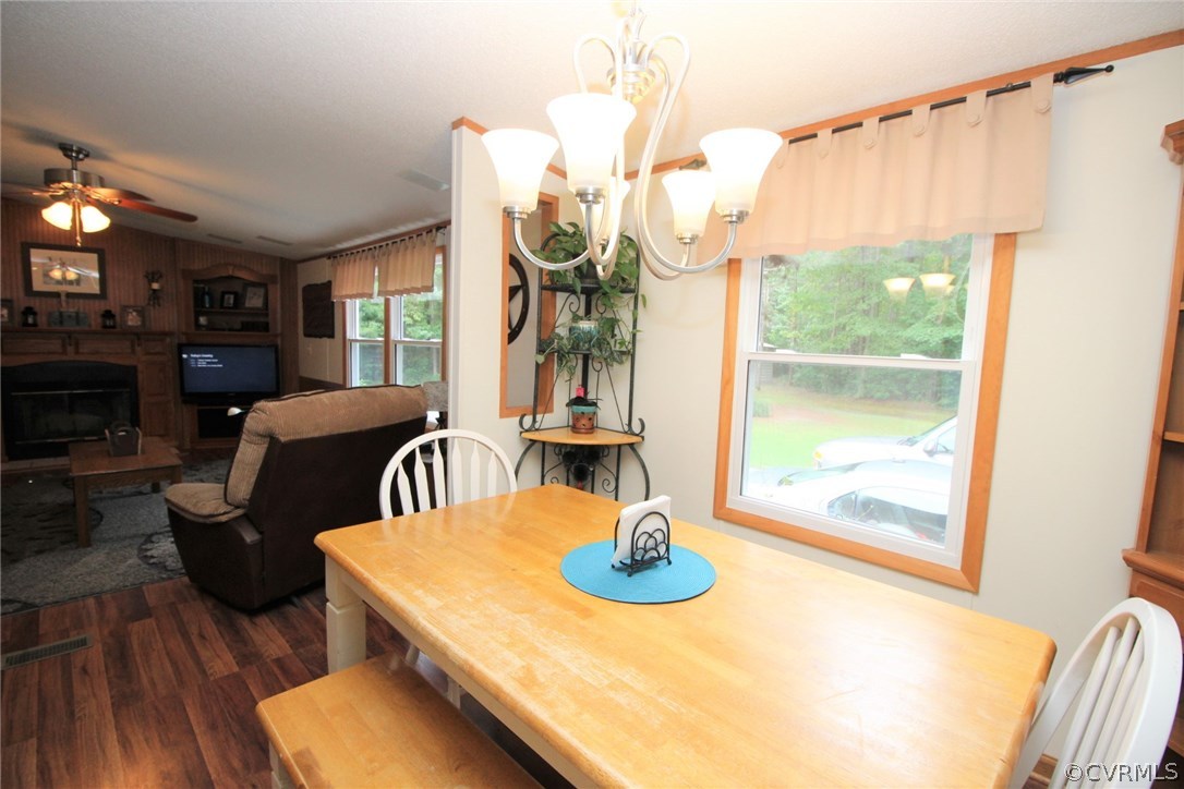 4278 Dorrell Road Aylett, VA 23009 - Photo 7 of 34 a view of a dining room with furniture a chandelier and wooden floor
