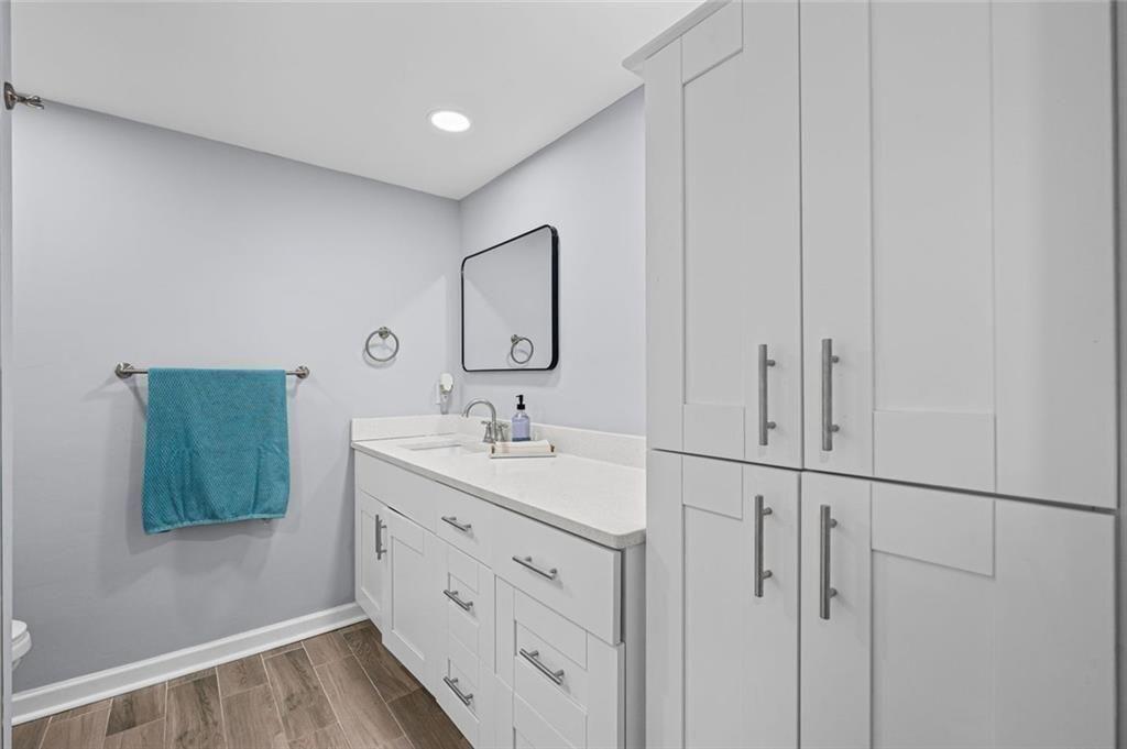 6851 Roswell Road, Unit E4 Atlanta, GA 30328 - Photo 11 of 26 a bathroom with 2 sink toilet and a mirror