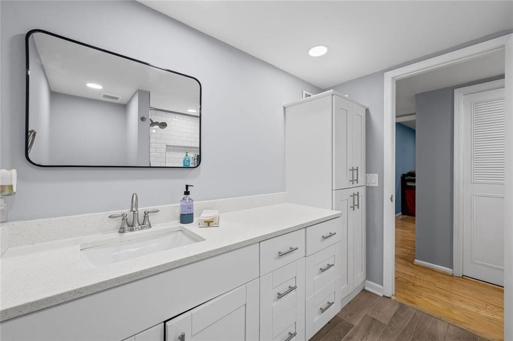 6851 Roswell Road, Unit E4 Atlanta, GA 30328 - Photo 12 of 26 a bathroom with a double vanity sink mirror and